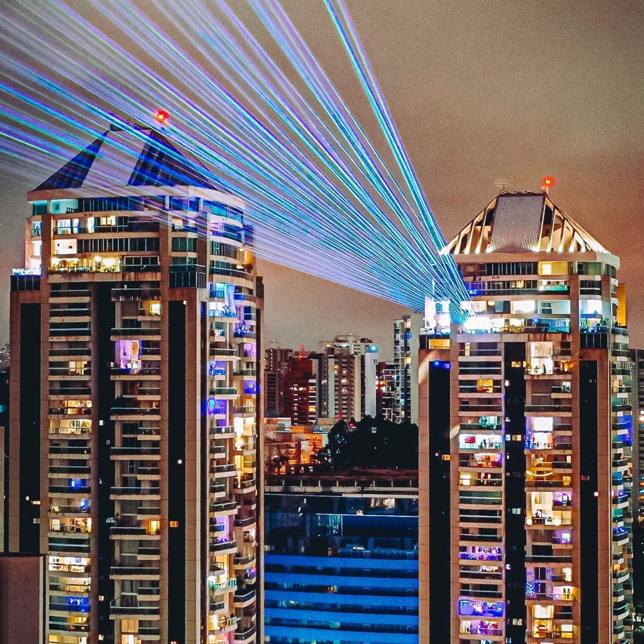 Bright laser rays illuminating from skyscraper at night
